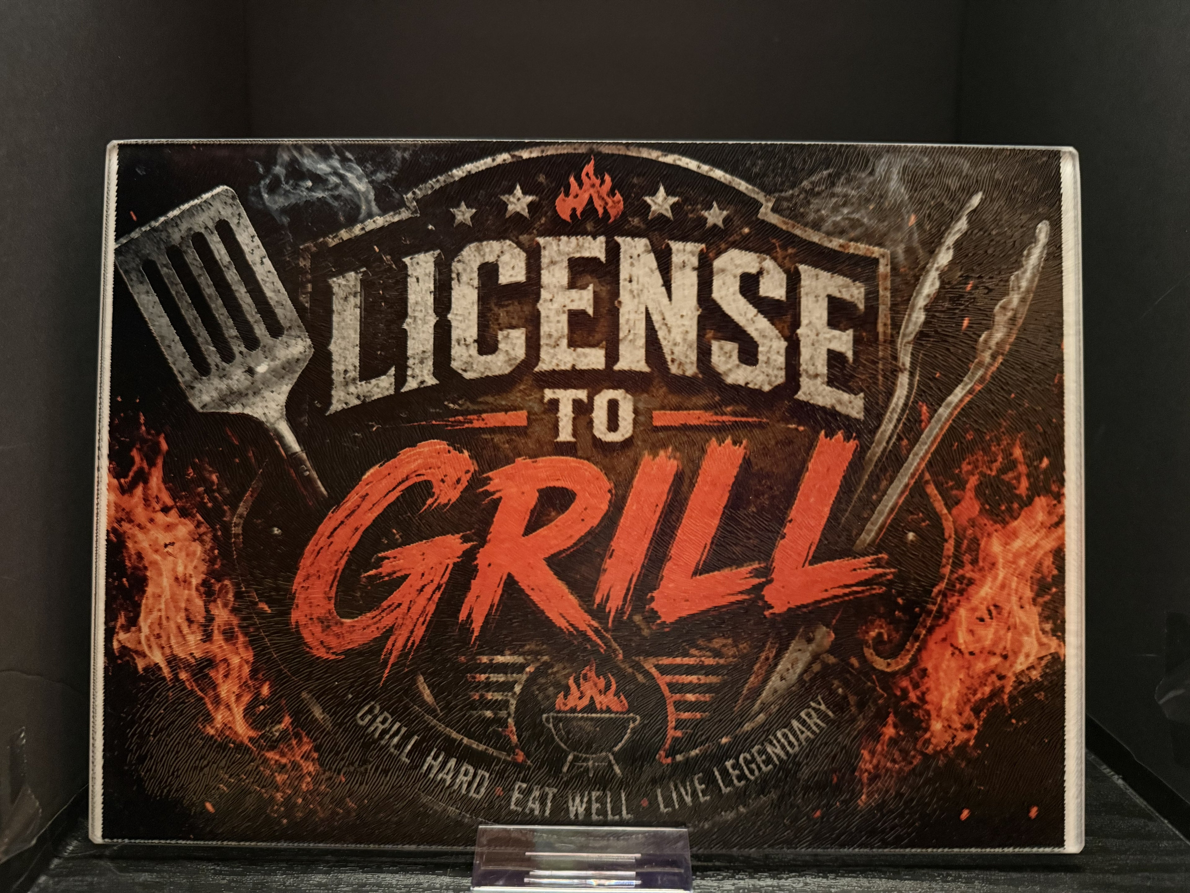 License to Grill. Grill Hard. Eat Well. Live Legendary. - 11"x7.87" Glass Cutting Board